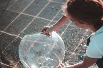 High angle view of man holding water
