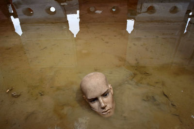 High angle portrait of shirtless on floor