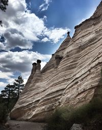 Low angle view of rock formations against sky