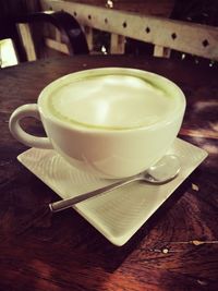 Close-up of coffee cup on wooden table