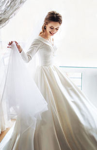 Portrait of young woman standing in tent