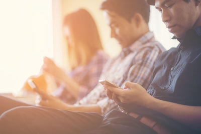 Side view of a man using smart phone