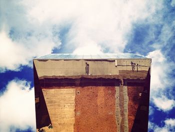 Low angle view of built structure against cloudy sky