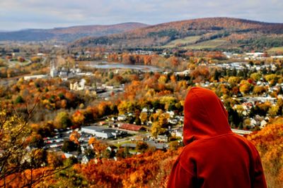 Rear view of people looking at cityscape during autumn