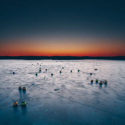 Scenic view of sea against clear sky during sunset