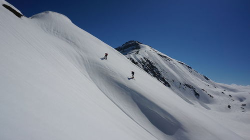 Scenic view of snowcapped mountain against clear sky