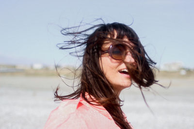 Close-up of smiling woman with tousled hair