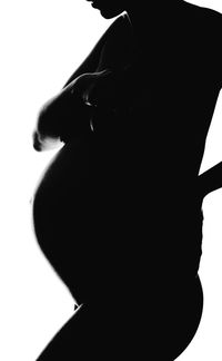 Rear view of silhouette woman against white background