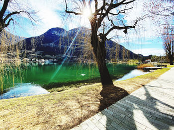 Scenic view of lake by mountains against sky