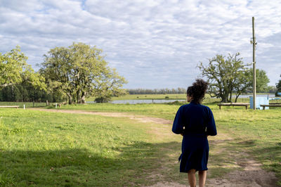 Woman walking outdoors in the field.