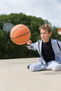 Boy playing with basketball at park