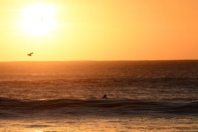 Scenic view of sea against clear sky during sunset