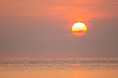 Scenic view of sea against romantic sky at sunset