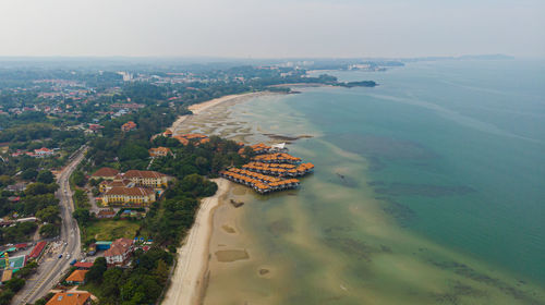 High angle view of buildings by sea against sky