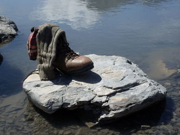 Low section of man on rock by sea