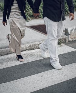 Low section of people walking on road