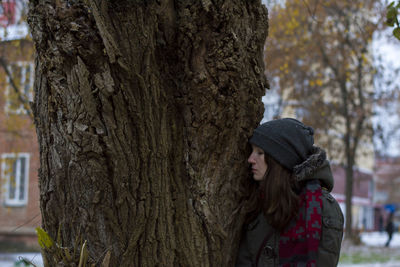 Woman near a tree trunk