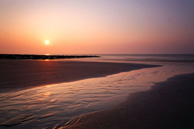 Scenic view of beach against sky during sunset