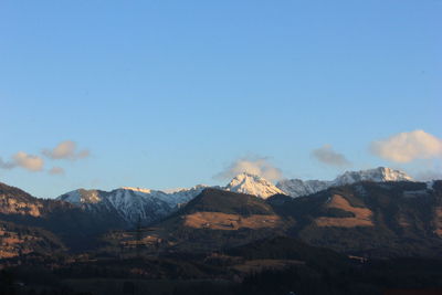 Scenic view of mountains against blue sky