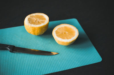 Close-up of lemon and slice on table