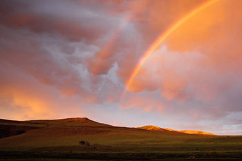 Scenic view of rainbow against sky during sunset