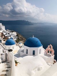 Panoramic view of sea and buildings against sky