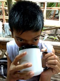 Portrait of boy drinking coffee