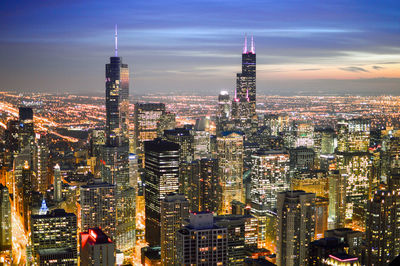 High angle shot of illuminated cityscape against sky