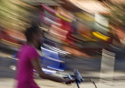 Blurred motion of woman in city