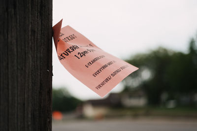 Close-up of paper on post