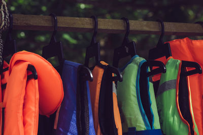 Multi colored clothes hanging in rack for sale at market stall