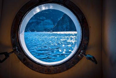 Close-up of sea seen through window