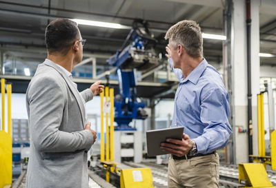 Manager and supervisor discussing about machinery in factory