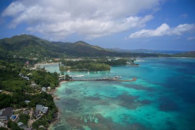 High angle view of townscape by sea against sky