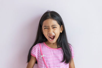 Portrait of a smiling girl over white background