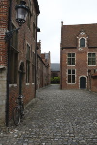 Footpath amidst buildings in city