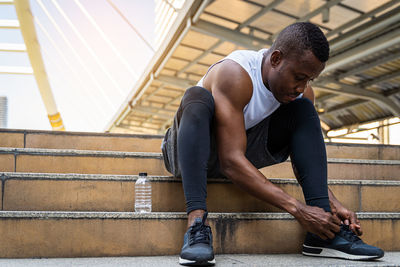 Man looking away while sitting outdoors