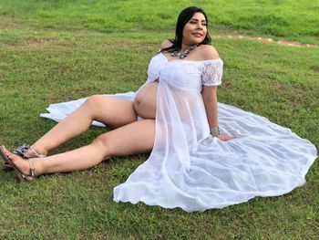 Young woman sitting on a field