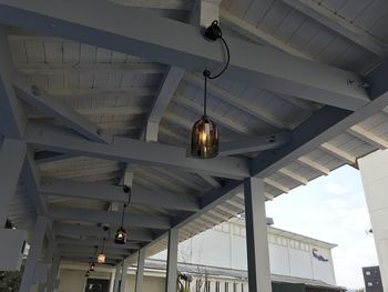 Low angle view of illuminated light hanging on ceiling in building