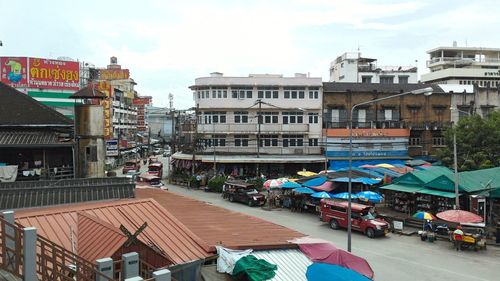 Group of people in city against sky