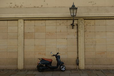 Bicycle parked on street against building