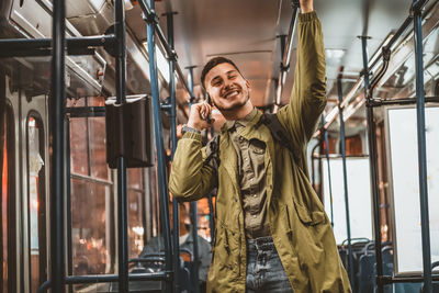 Man reading from mobile phone screen while traveling on metro. wireless internet on public transport