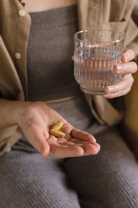 Midsection of woman holding food on table