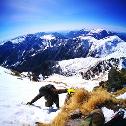 High angle view of hiker climbing snowcapped mountain