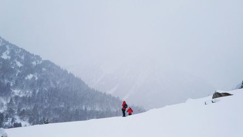 Man walking on snow covered mountain