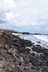 Rocks on beach against sky