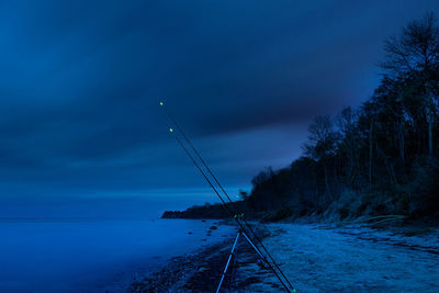 Scenic view of sea against blue sky at dusk