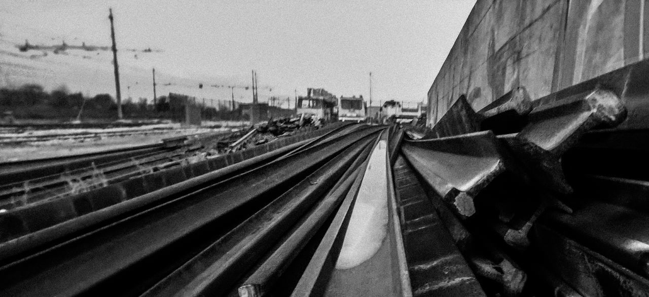 RAILROAD TRACK IN CITY AGAINST SKY