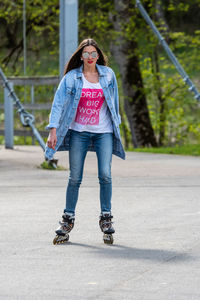 Full length portrait of woman standing outdoors