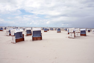 People at beach against sky